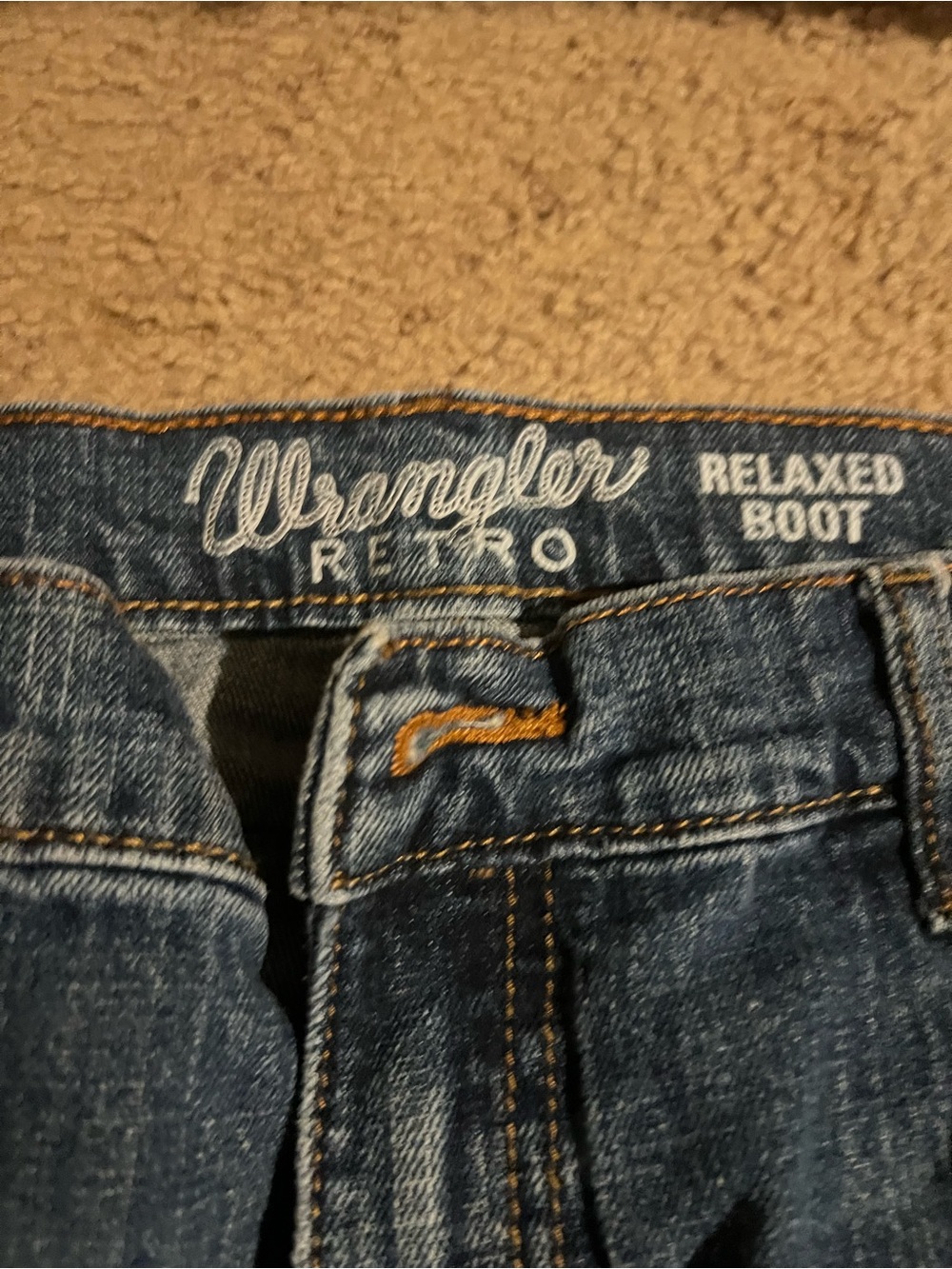 Wrangler Men's big whole on back pocket, easy to fix if you can sew